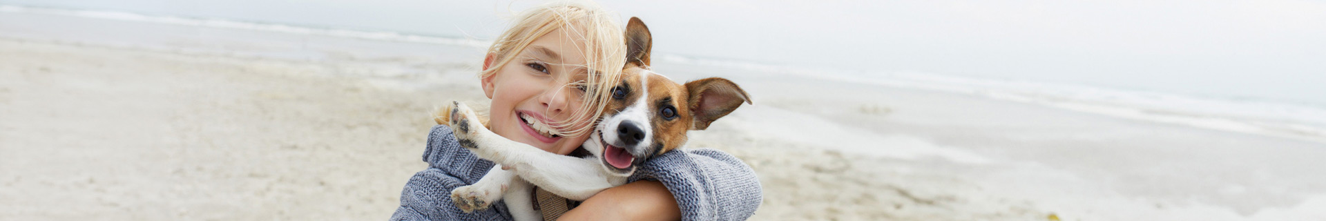 Girl with dog on beach